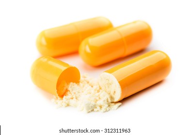 close up of open capsule isolated on white background