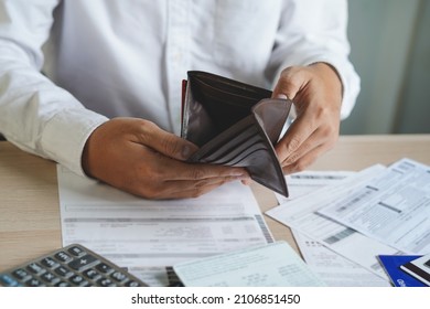 Close up open empty wallet of broke people on payday - Shutterstock ID 2106851450