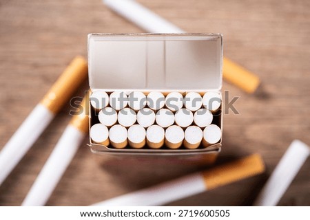 Close up of open pack of cigarettes on table