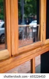 Close Up Of Open Text On Glass Window Of Side Walk Cafe