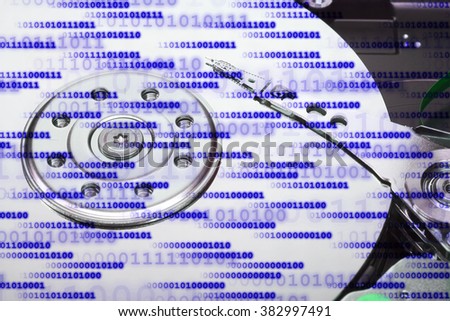 Close up of an opened hard disk with visible read head.
