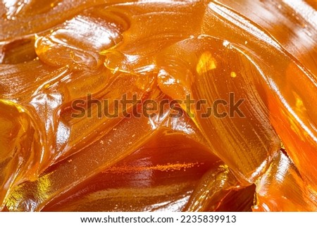 Close up of orange colored industrial grease. Rich and thick texture of industrial grade grease used to smooth out all metal friction. Lubricating grease. close-up of yellow lithium grease for machine