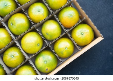 Close up orange fruit arranged in a paper carton box for export