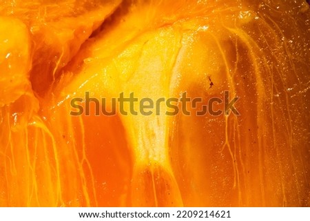 Close up of the orange glowing flesh of a Sharon fruit