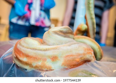 Close Up Of Orange And Green Foam On Table From A Science Experiment In An Educational Lab Setting For Kids.