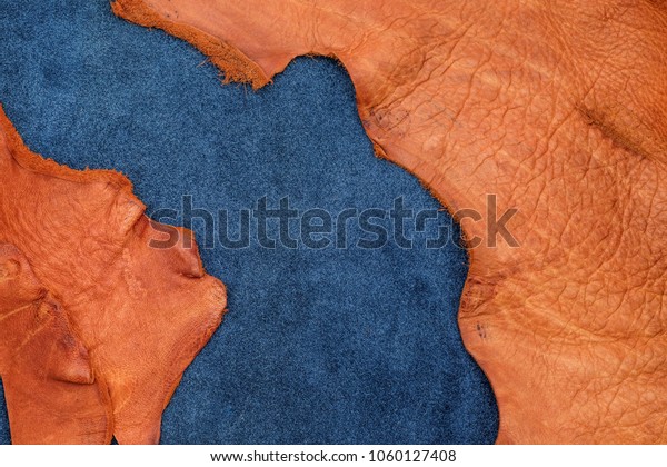 Close up\
orange rough edge and navy blue leather divide in two section,\
fashion texture background,fabric\
division.