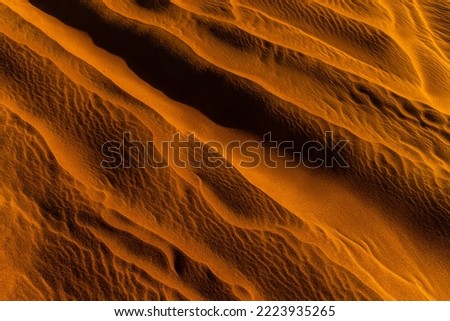 Close up orange sand texture in Empty Quarter Desert in United Arab Emirates. Sand dunes. Abstract sand texture.