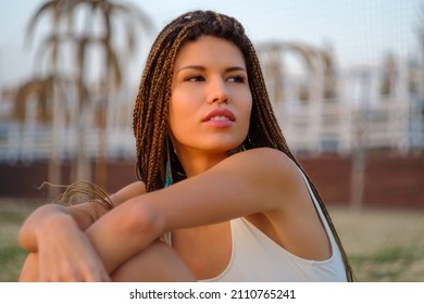 Close up outdoor portrait of attractive asian european model girl with braided hairstyle.