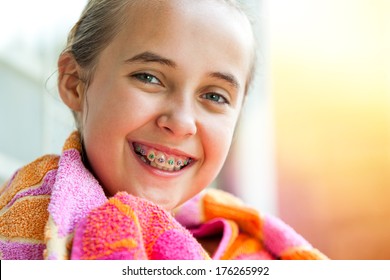 Close up outdoor portrait of cute kid with dental braces smiling. 