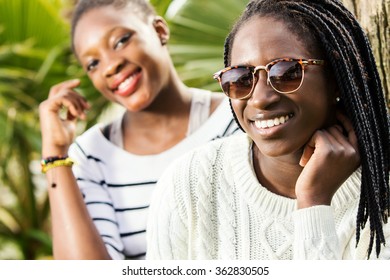 Close Up Outdoor Portrait Of Two African Teen Girlfriends.One Girl Wearing Sun Glasses.