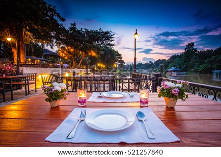 Close up of outdoor restaurant table in the evening in Thailand.