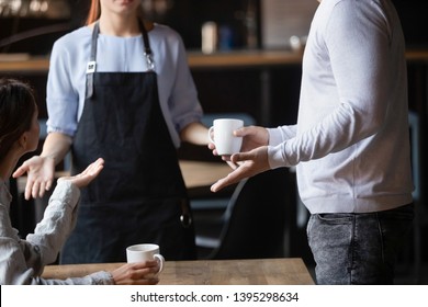 Close up outraged customers arguing with waitress in coffeehouse, bad service concept, unhappy angry man and woman displeased by drinks poor quality, talking, conflicting with cafe worker