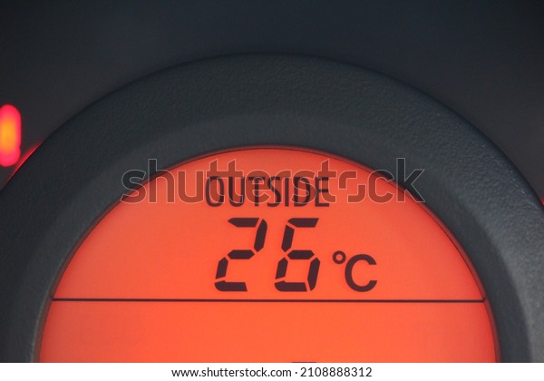 Close up of an outside temperature gauge in a budget\
vehicle 