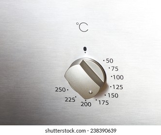 Close Up Of Oven Knob On Metal Board