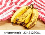 Close up of Over Ripe Bananas isolated of a wooden background with copy space
