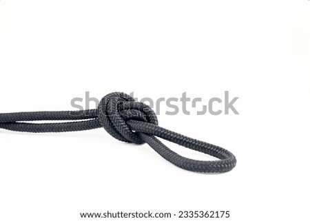 close up of an overhand knot tied with parachute  or climbing rope for nautical or mountaineering applications
