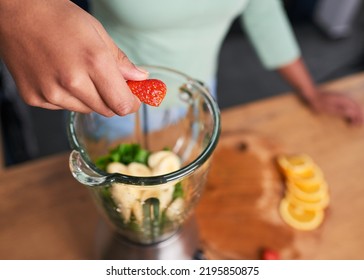 Close Up Overhead Shot Of Hands Preparing Smoothie In Glass Blender Strawberry