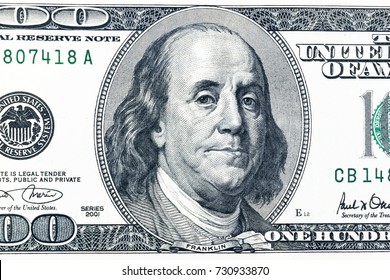 Close Up Overhead View Of Benjamin Franklin Face On 100 US Dollar Bill. US One Hundred Dollar Bill Closeup. Heap Of One Hundred Dollar Bills On Money Background. 