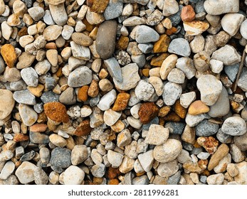 Close up overhead view of a dense collection of small colorful pebbles and stones