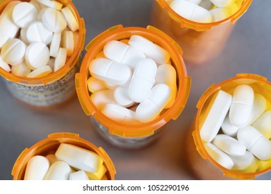 Close Up Overhead View Of Full Prescription Bottles On Stainless Steel Background 