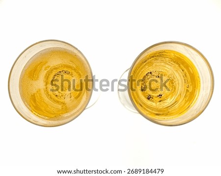 Close up overhead view of two glasses on champagne isolated n a plain white background