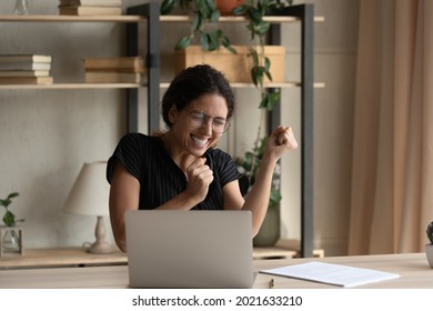 Close up overjoyed businesswoman in glasses celebrating success, yes gesture, using laptop, sitting at desk, excited woman received good news in message, project results, student get scholarship - Shutterstock ID 2021633210