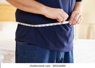Close Up Of Overweight Man Measuring Waist - Shutterstock ID 205314403