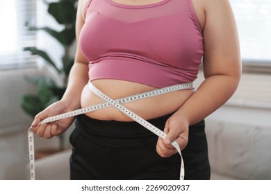 Closeup of slim black lady measuring her hips Stock Photo by