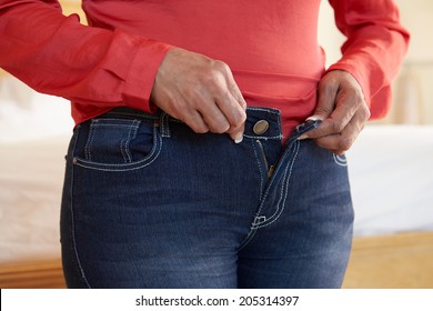 Close Up Of Overweight Woman Trying To Fasten Trousers - Shutterstock ID 205314397