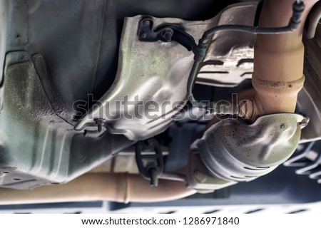 Close up oxygen sensor on Catalyst pipe of gasoline engine car on the hoist lift for service and repair in Garage shop
