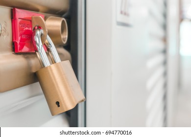 Close Up Of A Pad Lock On A White Storage Unit.