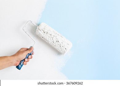 Close Up Of Painter Arm Painting A Wall With Paint Roller; Copy Space