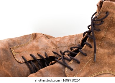 close up of a pair of brown mens leather boots isolated on white background