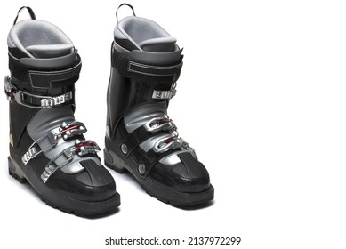 Close Up Of A Pair Of Two Black Ski Boots With Gray Lining And Three Buckles Standing Next Each Other On White Background