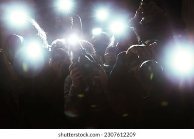 Close up of paparazzi photographers pointing cameras