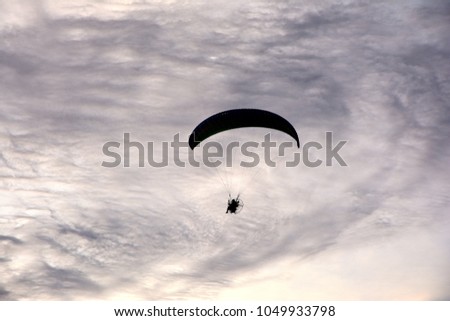 Close up of Para gliding flying on the sky cloud black and white background,one man show flying paragliding