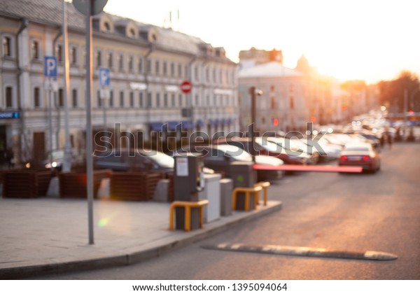 Close up of parking ticket\
machine and barrier gate at the entrance of parking area. Blurred\
concept view of modern europe cityscape. Business center of old\
town. 