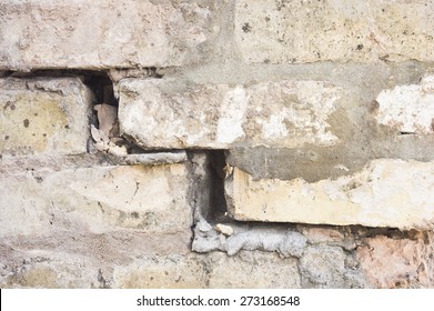 Close up of part of a damaged brick wall