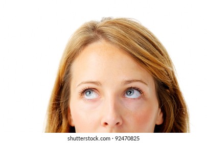 Close up of a partial woman's face looking up towards a corner