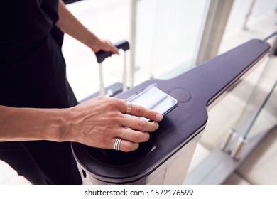 Close Up Of Passenger In Airport Departure Lounge Scanning Digital Boarding Pass On Smart Phone