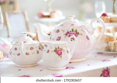 Close Up Of Pastel Pink Royal Doulton Teapot And Tea Set For An Elegant High Tea  Party Table Set Up An Assortment Of Cupcakes, Sweets And Pastries.