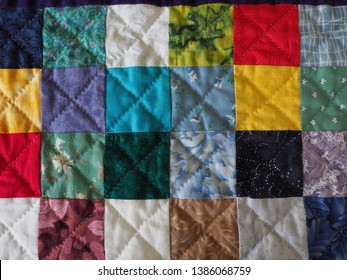 Close up of Patchwork Charm Squares Quilt and Hand Quilting