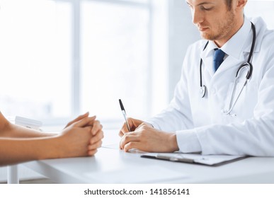 close up of patient and doctor taking notes - Powered by Shutterstock