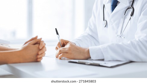 close up of patient and doctor taking notes - Shutterstock ID 271845803