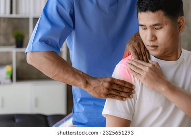 Close up patient hand doing stretching with physiotherapy to help in clinic room Therapist treats injured man with rotator cuff stretching method