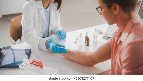 Close Up of a Patient Passing a Prick Scratch Allergy Test. Allergist Using Different Allergens on a Skin of a Young Man. Immunologist Diagnosing Allergy Triggers - Powered by Shutterstock