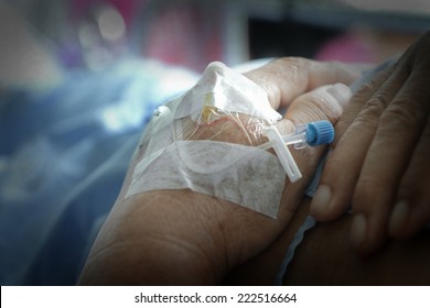 Close Up Of Patient's Hand With Iv Solution Set.