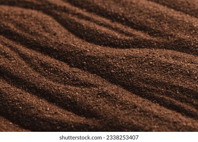 Close up of pattern of brown sand and copy space background. Sand, texture, movement, shape and colour concept.