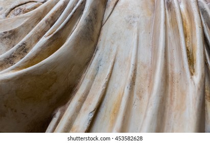 Close Up Of Pattern Of Flowing Fabric Folds Of Marble Sculpture.