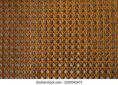 Close Up Of The Pattern Formed By Open Weave Rattan Cane On A Chair Seat